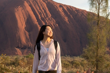 women walking around uluru